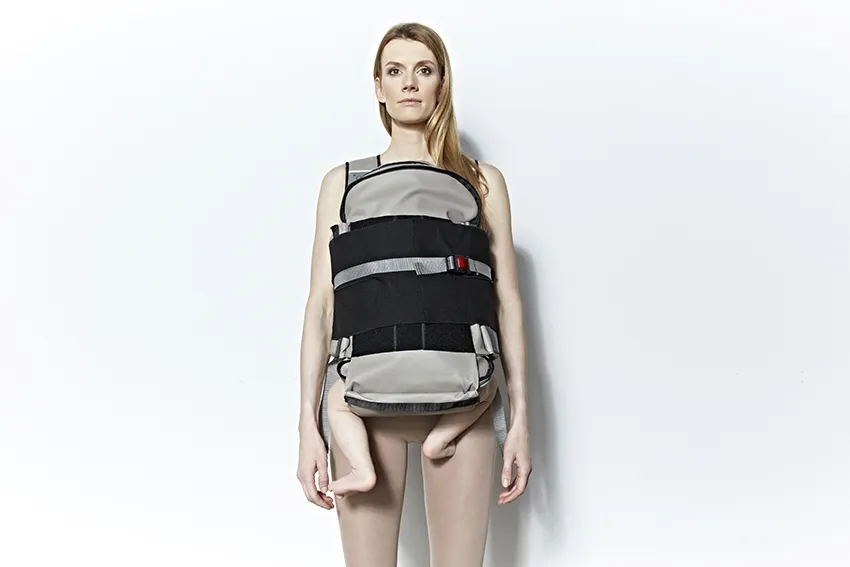 Traveling bag – backpack with included hood, with 5 chambers and removable parts. After the removing process, the removable part may be placed in front parts of the torso, and mounted on elastic gums with use of inluded bur-tapes, and carrier tapes. The length of tapes is designed to fit people sized 5 to 95 centils.