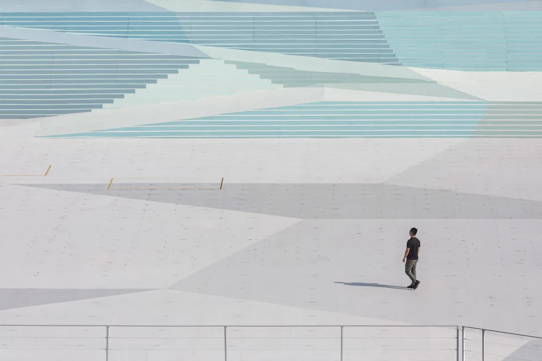 Through this, we hope to bring the bay closer to the stage and the show closer to the city. The scale of the stage is brought closer to the human scale by a pattern painted throughout the stage floor. The floor pattern is centred on the pentagon defined by the formation of the five stars of the State Flag in the first act of the show. A tessellated pattern radiates from this pentagon, anchoring the heart of the stage